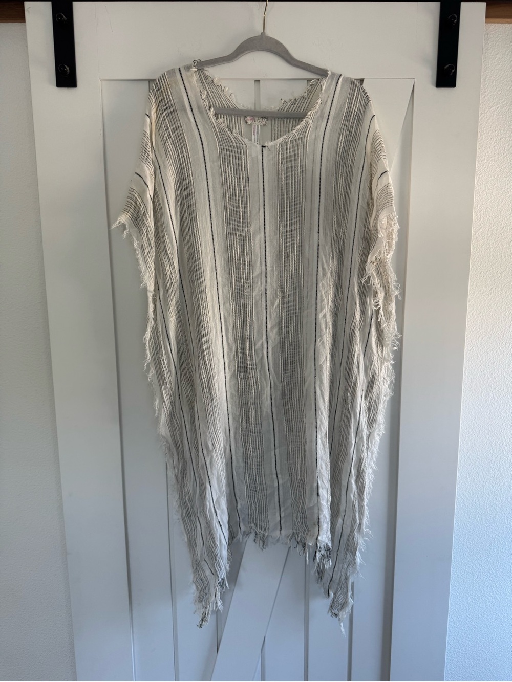 Free People poncho/cover-up w/ metallic striped design & frayed edge details.